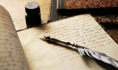 quill ink pot and poetry book
